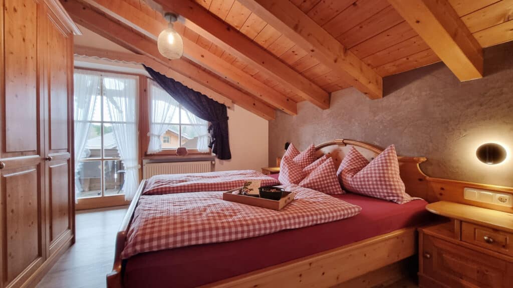 Ferienwohnung Wetterstein_gemütliches Schlafzimmer mit viel Holz im Alpenparadies Kruen